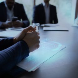 men at desk in office in a meeting