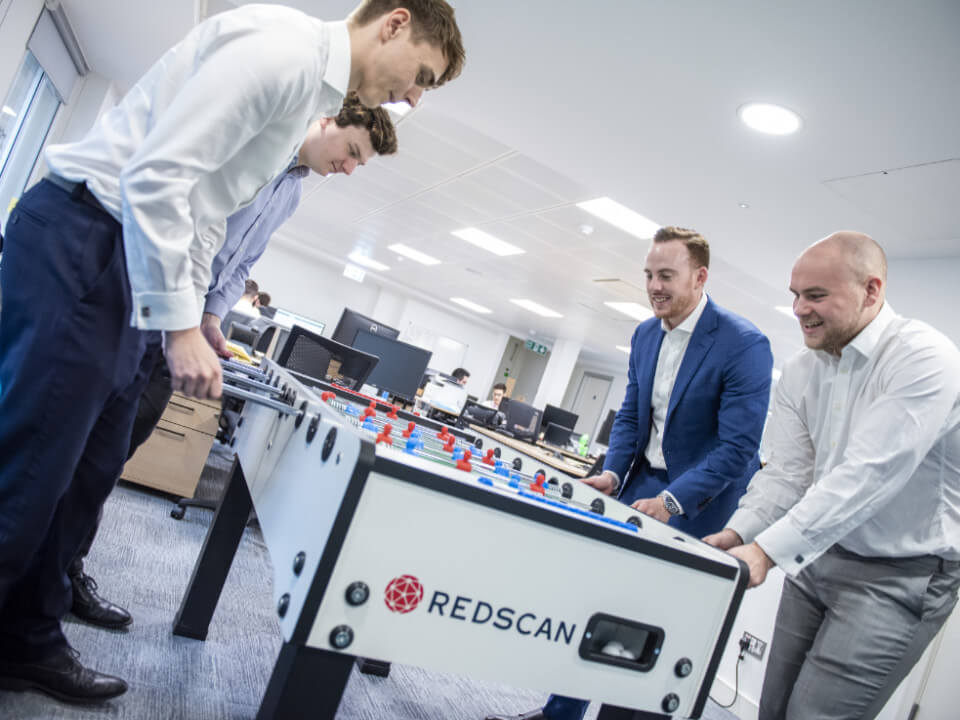 Team members playing table football